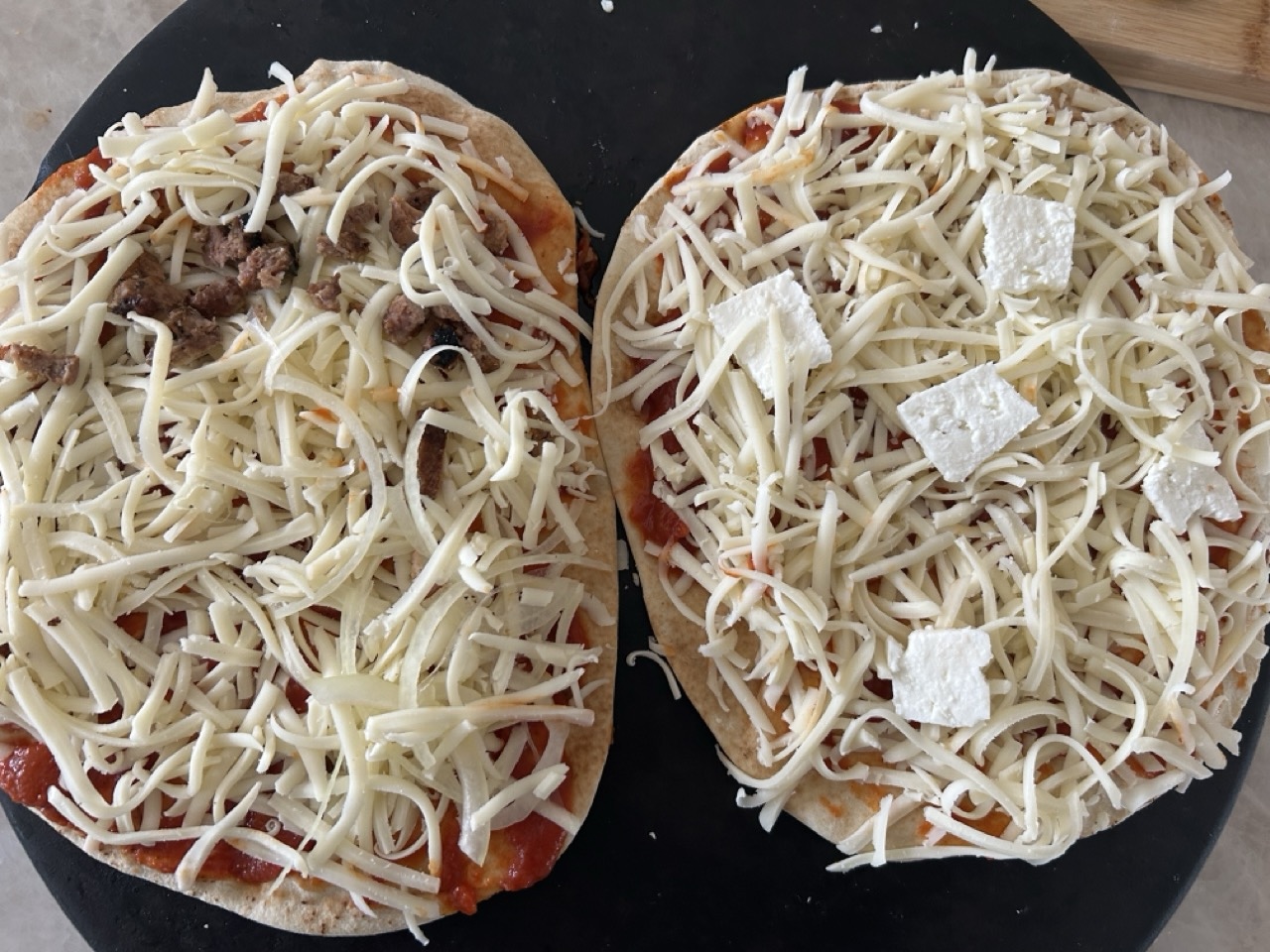 Alt Text: Basic pita pizza with sause, cheeese and minimal topings.  The way kids like it.